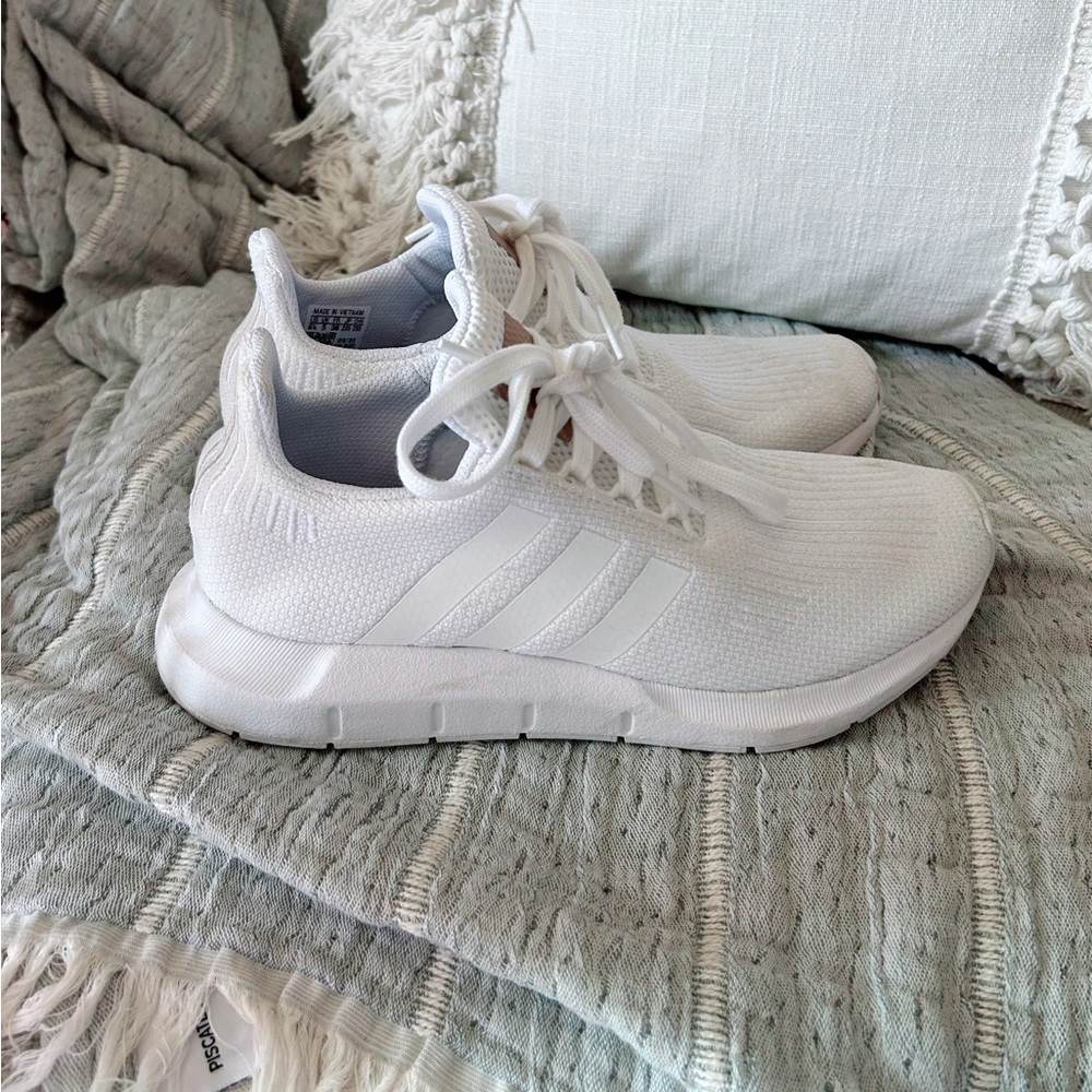 Women’s white Adidas sneakers